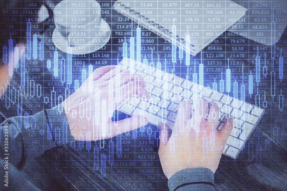 Double exposure of graph with man typing on computer in office on background. Concept of hard work. Double exposure of graph with man typing on computer in office on background. Concept of hard work.