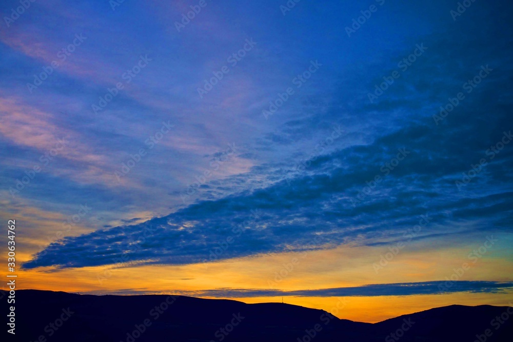 blue sunset sky and beautiful blue sky background with clouds and sunlight beams