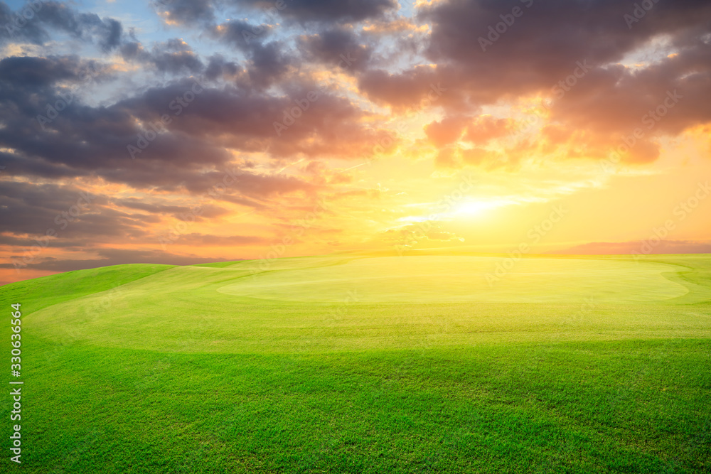 Green grass field and colorful sky clouds at sunset. Green grass field and colorful sky clouds at sunset.