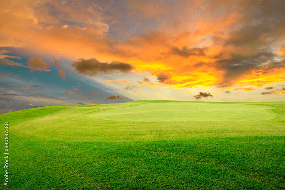 Green grass field and colorful sky clouds at sunset. Green grass field and colorful sky clouds at sunset.
