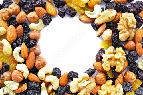 Mix of nuts - cobnut, cashew, almond, Walnut, Brazil nut and dry fruit – raisin. The concept of healthy eating with empty round in center copy space. Top view