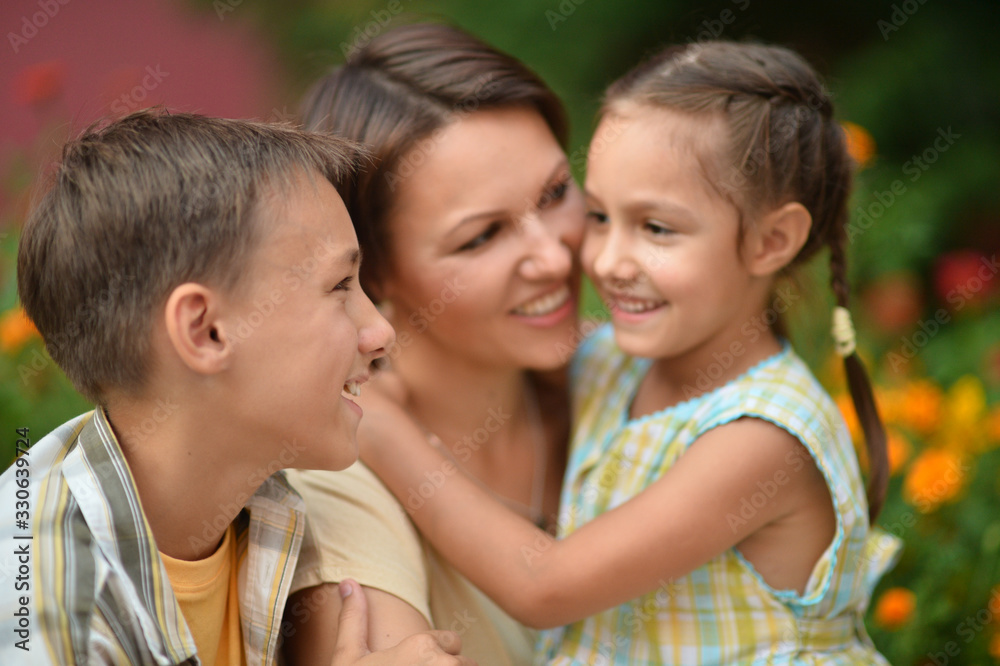 Portrait of happy mother and children in park Portrait of happy mother and children in park