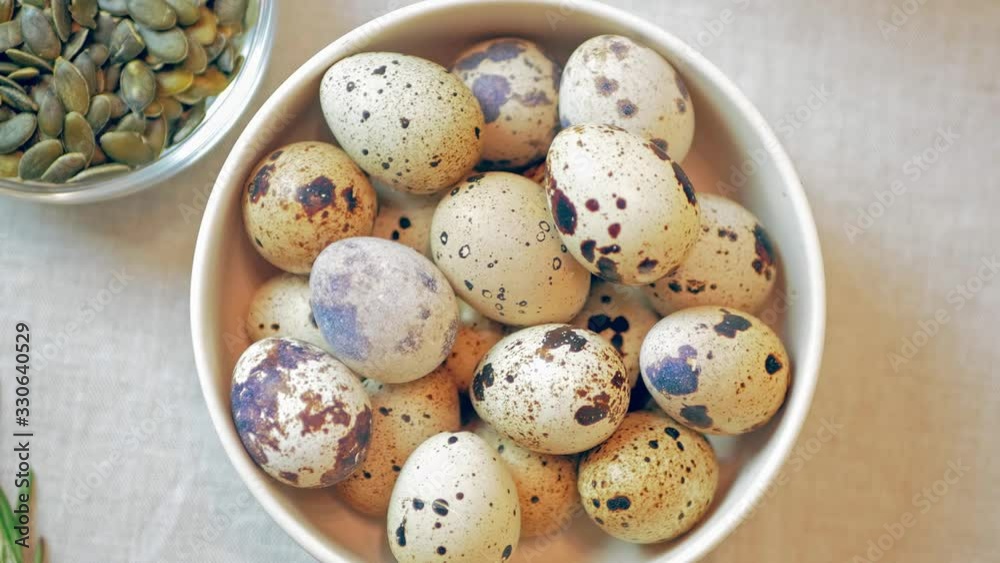 Quail eggs in a bowl on a table. eating organic food in the kitchen Quail eggs in a bowl on a table. eating organic food in the kitchen