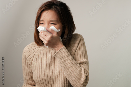 asian woman sneezing because infection from germ, bacteria, covid19, corona , sars , influenza virus on white background. Sick and illness concept