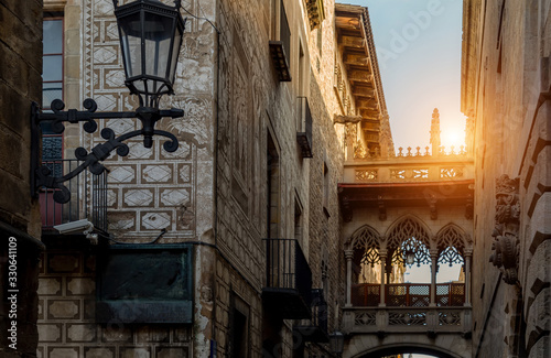 Cathedral of Barcelona in Las Ramblas at sunset and Famous Bridge of Sighs (Pont del Bisbe) photo