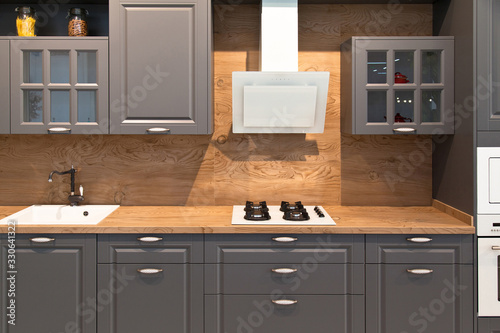 Interior of modern kitchen equipment and grey cabinets