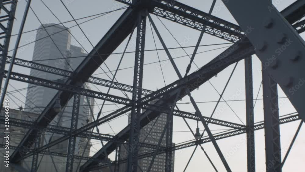 City skyline view through a steel bridge truss City skyline view through a steel bridge truss