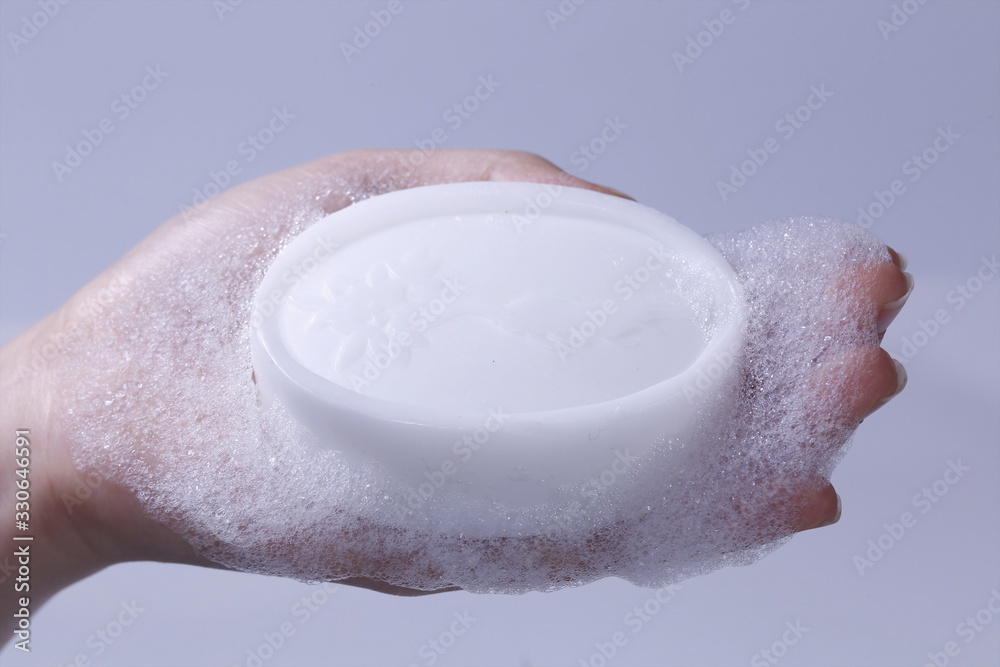 Fototapeta premium The novel coronavirus pneumonia is scientifically washed by holding a white foam on one hand, disinfecting hand soap or disinfecting soap with 75% alcohol.