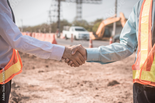 Businessman two people shake hand success at construction site partnership community