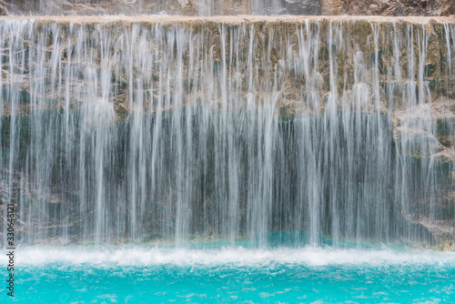 Fototapeta Naklejka Na Ścianę i Meble -  landscape of beautiful Artificial waterfall in garden at the public park