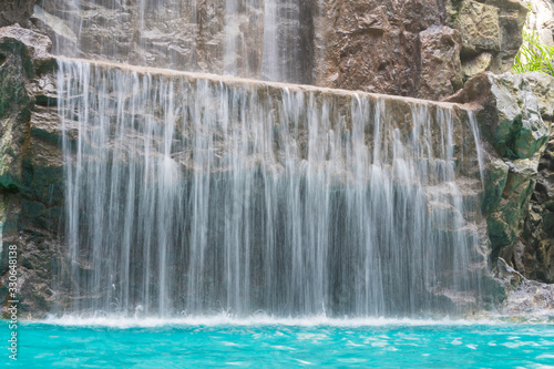 landscape of beautiful Artificial waterfall in garden at the public park
