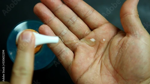 Man washing hands with algohol gel , indoor  Chiangmai Thailand photo