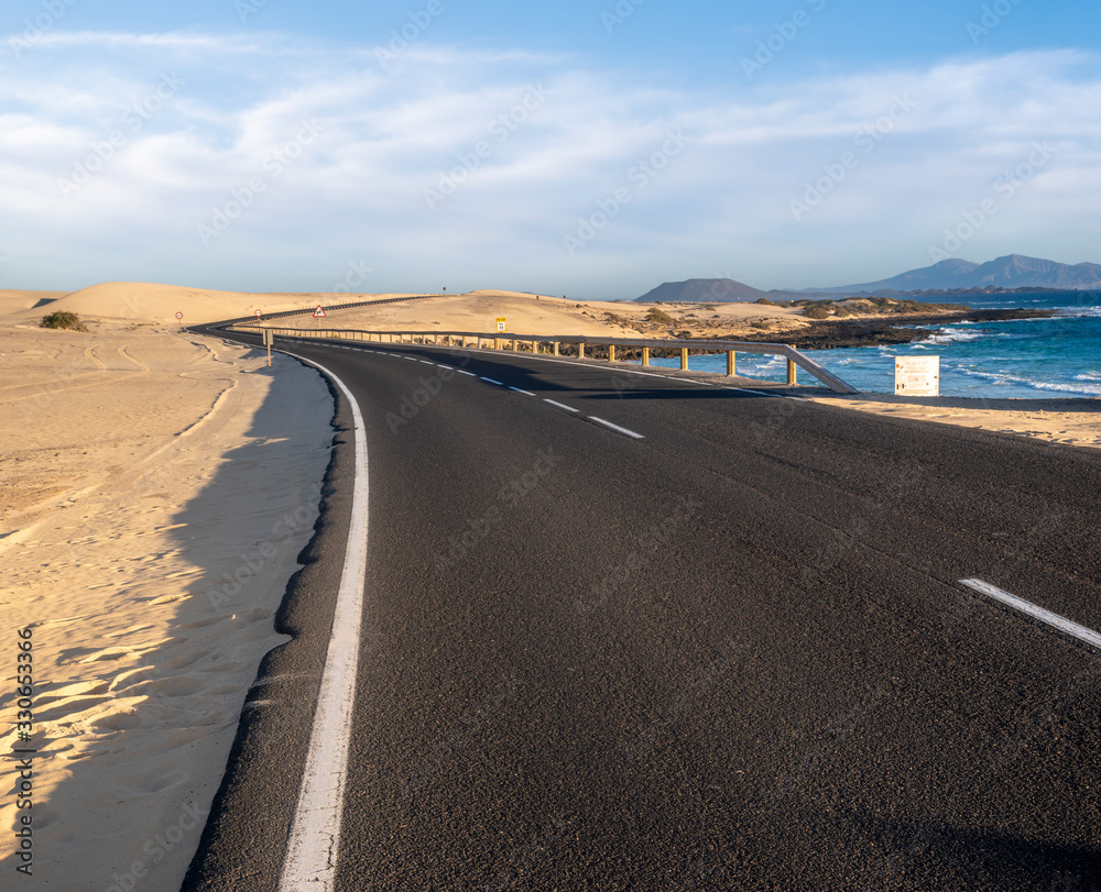 asphalt road running through the sands of Dunas Corralejo in Fuerteventura