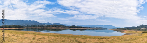 The reservoir under blue sky and white clouds and its ecological environment