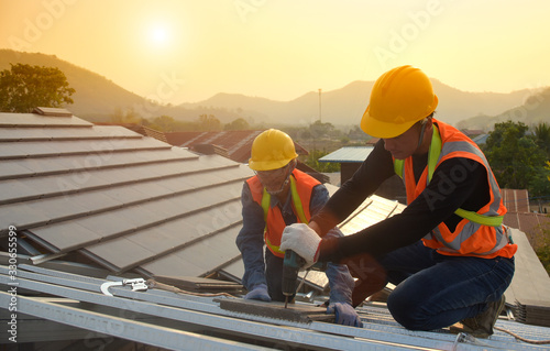 Construction Industry. Roofer with Ceramic Tiles in Hands. Roof Worker Closeup. House Rooftop Covering  Roof construction. photo