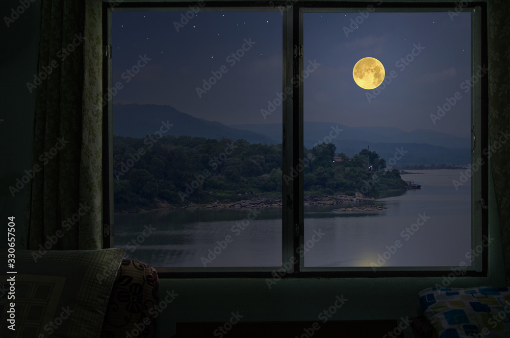 Beautiful full moon over the river from window view point