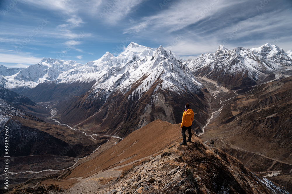 Trekker stand on top of Samdo Ri view point in Manaslu circuit trek, Himalaya range in Nepal Trekker stand on top of Samdo Ri view point in Manaslu circuit trek, Himalaya range in Nepal