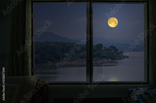 Beautiful full moon over the river from window view point