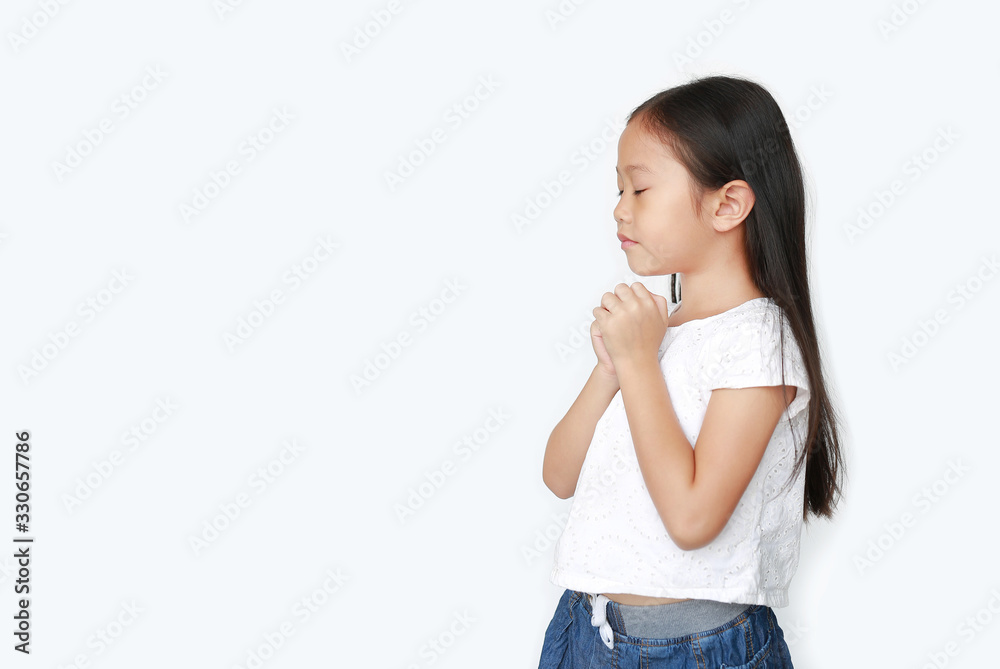 Close eyes beautiful little asian child girl praying isolated on white background with copy space. Spirituality and religion concept. Close eyes beautiful little asian child girl praying isolated on white background with copy space. Spirituality and religion concept.