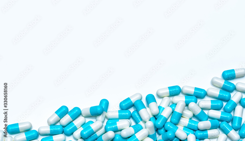 Pile of antibiotic capsule pills isolated on white background. Global market trends of antimicrobial drugs concept. Antibiotic drug resistance. Pharmaceutical industry. Pharmacy drugstore products.