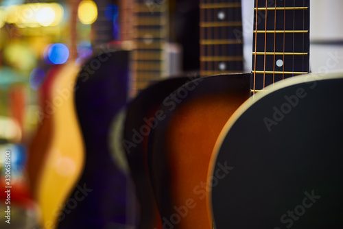 Row of classic acoustic guitars in the shop