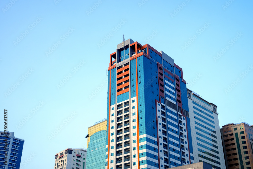 United Arab Emirates, UAE 3.MARCH.2020: Perspective and underside angle view to textured background of modern glass  blue building skyscrapers roof.