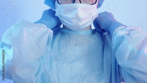 Coronavirus protection. Healthcare service. Female doctor in face mask wearing gloves. photo