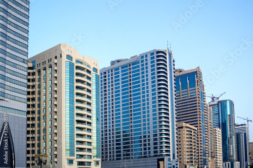United Arab Emirates, UAE 3.MARCH.2020: Perspective and underside angle view to textured background of modern glass blue building skyscrapers roof.