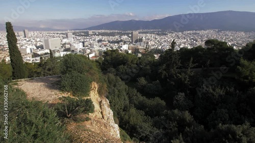 Tracking shot over a path and towards a cliff in Lycabettus with the city of Athens in the background photo