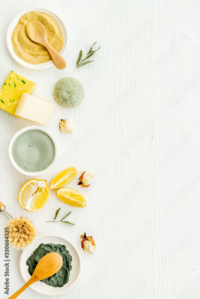Face, body skin care homemade ingredients - cosmetic clay, brushes, homemade soap, scrub, herbs on a white background. Top view Face, body skin care homemade ingredients - cosmetic clay, brushes, homemade soap, scrub, herbs on a white background. Top view