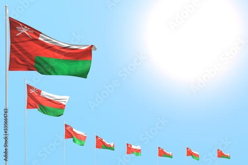 cute labor day flag 3d illustration. - many Oman flags placed diagonal on blue sky with space for content