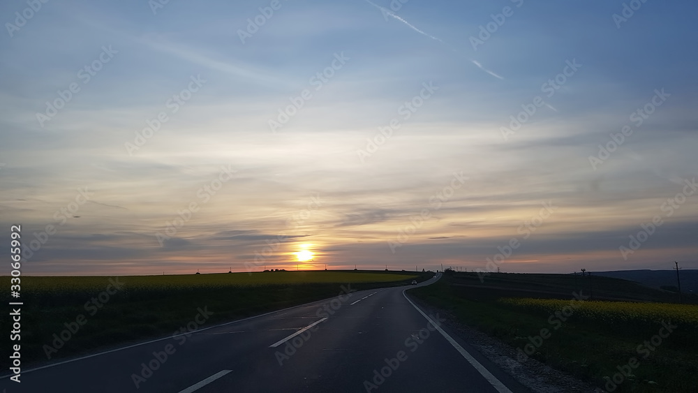 national road in the background with sunset