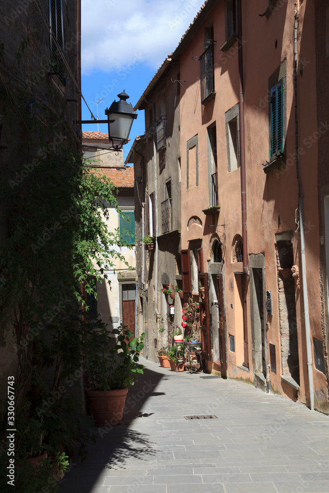 Scansano (GR), Italy - June 10, 2017: A central road and typical houses in Scansano, Grosseto, Tuscany, Italy