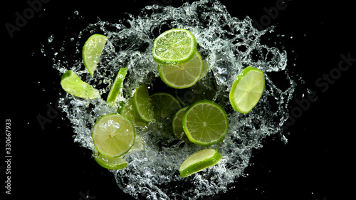Flying lime slices in water splash