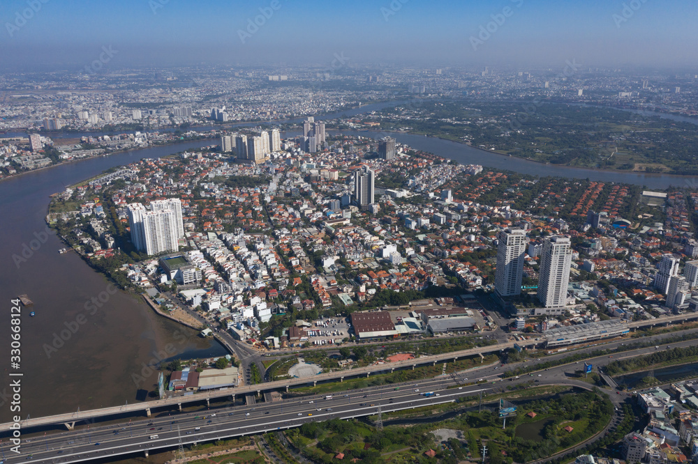Obraz premium Top view aerial photo from flying drone of a Ho Chi Minh City with development buildings, transportation, energy power infrastructure