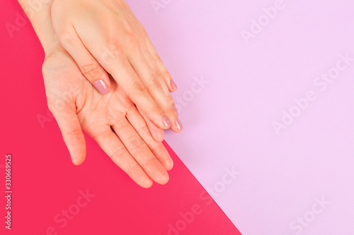 female  manicure. Beautiful young woman s hands on color pink  background - Image