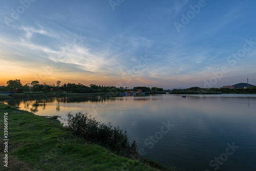 The lake at dusk reflects the scenery by the lake © chen