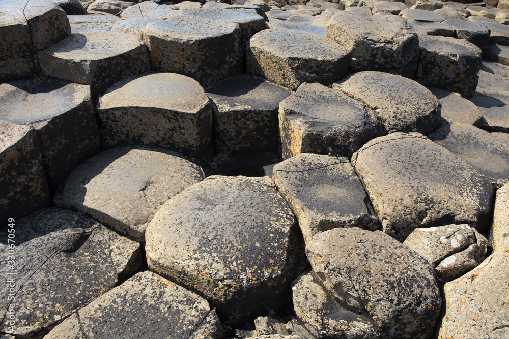 Ulster (Ireland), - July 20, 2016: Polygonal basalt lava rock columns of the Giant's Causeway on the north coast of County Antrim, Northern Ireland, UK Ulster (Ireland), - July 20, 2016: Polygonal basalt lava rock columns of the Giant's Causeway on the north coast of County Antrim, Northern Ireland, UK