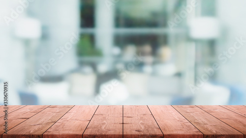 Empty wood table top and blurred home interior with window room background. - can used for display or montage your products. © bunditinay