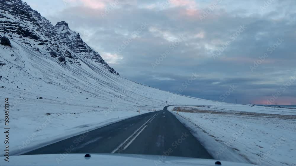 Driving in icelandic winter. Blowing snow across the road. Difficult driving conditions in winter season in Iceland. Icelandic route troubles. Icelandic safety driving. Driving in icelandic winter. Blowing snow across the road. Difficult driving conditions in winter season in Iceland. Icelandic route troubles. Icelandic safety driving.