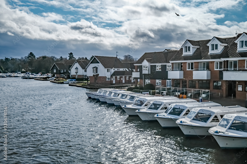  Fleet of day boats moored up in the boat yard on the River Bure in the village of Hoveton and Wroxham