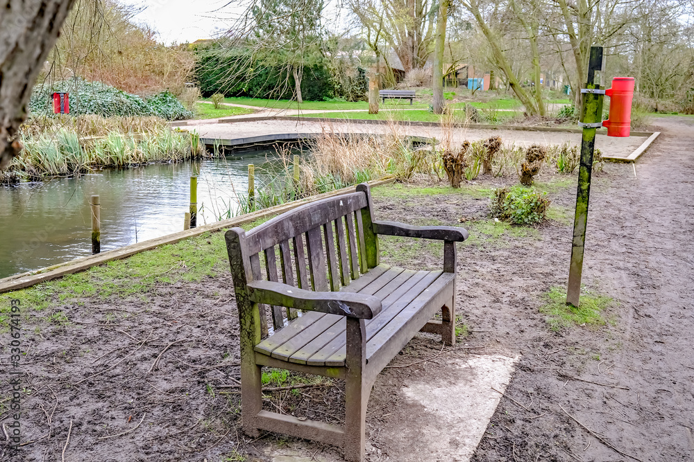 Wooden bench in public park in the village of Hoveton and Wroxham Wooden bench in public park in the village of Hoveton and Wroxham
