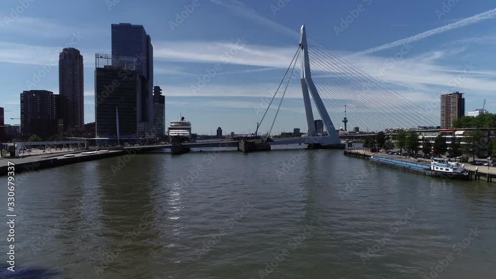 Low altitude aerial view of Rotterdam city centre showing the cable-stayed and bascule Erasmus Bridge and Maastoren building moving past Noordereiland island beautiful summer day 4k high resolution Low altitude aerial view of Rotterdam city centre showing the cable-stayed and bascule Erasmus Bridge and Maastoren building moving past Noordereiland island beautiful summer day 4k high resolution