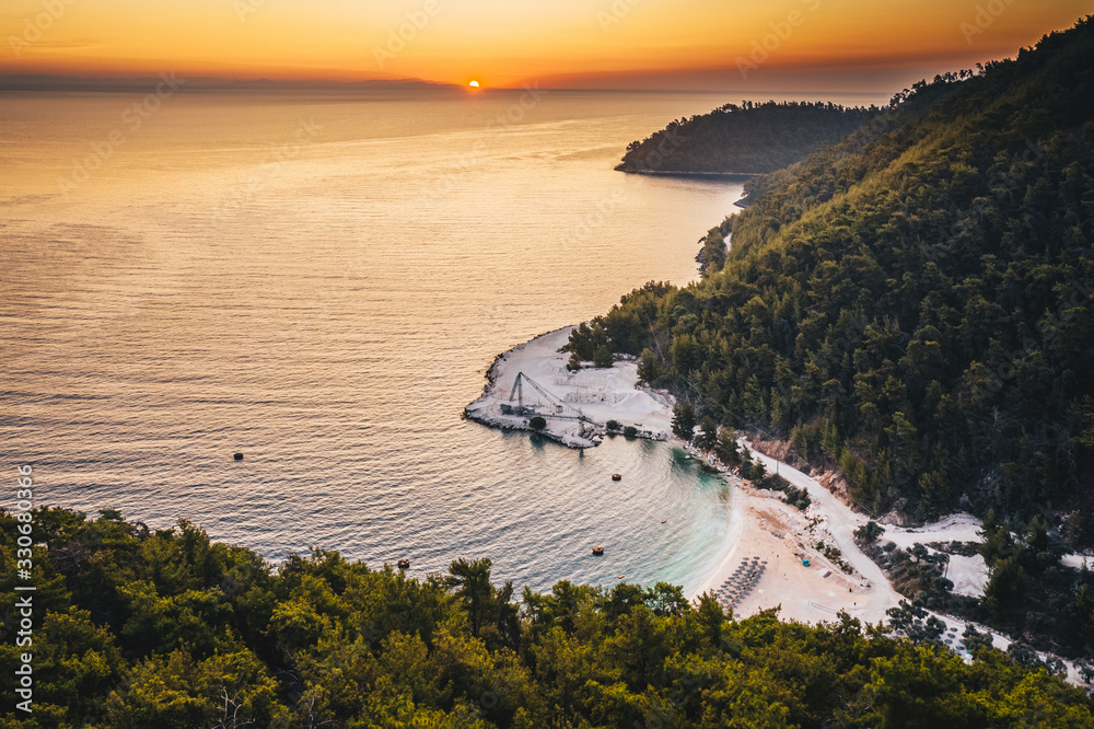 Sunrise over marble beach Porto Vathy in Thassos Island Greece
