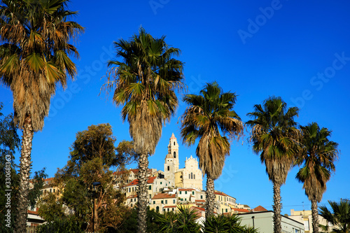 Cervo (IM), Italy - December 30, 2017: Cervo village view trough palms trees, Italian Riviera, Imperia, Liguria, Italy