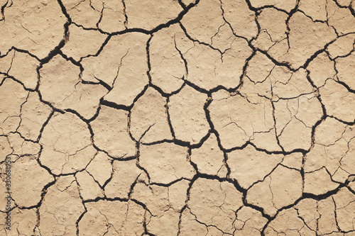 Top view of the dried up cracked soil. Drought, crop failure, global warming, climate change concept. Abstract texture background