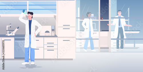 scientist working in medical lab researchers in white coats making chemical experiment modern laboratory interior research concept full length horizontal vector illustration