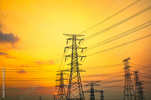 Industrial high voltage electricity tower and beautiful nature landscape at summer sunset