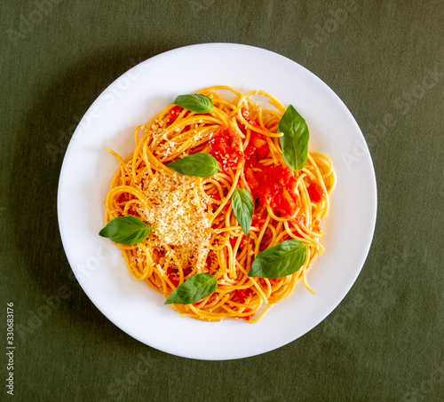 Pasta spaghetti with tomatoes, basil and parmesan cheese. Italian cuisine. Recipe. Vegetarian food. Healthy eating.
