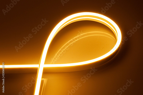 Flexible warm white LED neon strip on black background